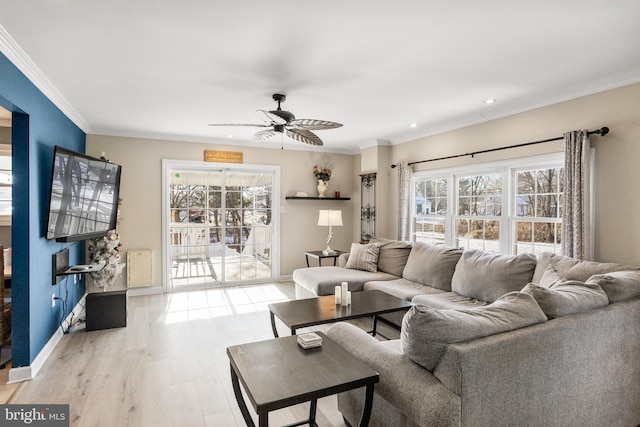 living room featuring light hardwood / wood-style flooring, ceiling fan, and crown molding