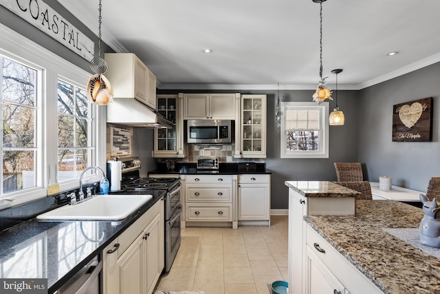 kitchen featuring sink, stainless steel appliances, backsplash, pendant lighting, and light tile patterned floors