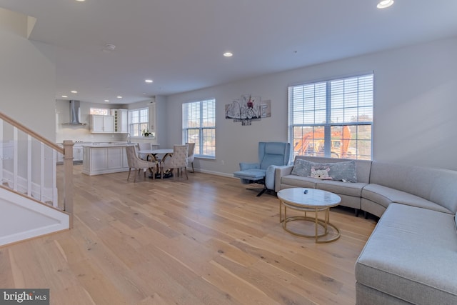 living room with plenty of natural light, light wood-type flooring, and sink