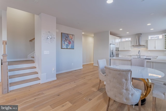 dining space featuring light hardwood / wood-style floors and sink