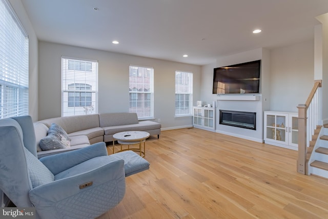 627 Halsey Way, Oxon Hill, MD 20745 - living area featuring wood finished floors, plenty of natural light, recessed lighting, and a glass covered fireplace