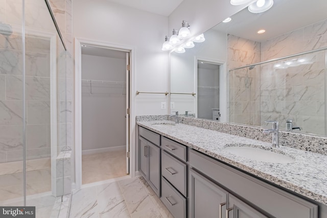 bathroom featuring vanity and an enclosed shower