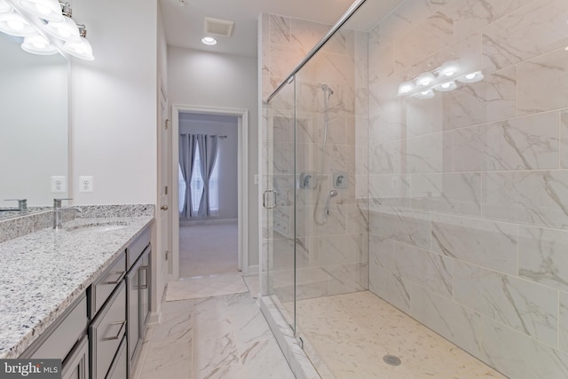 bathroom with vanity and an enclosed shower