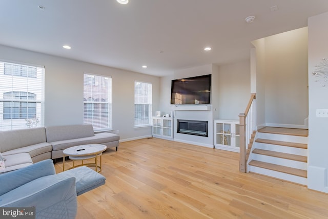 627 Halsey Way, Oxon Hill, MD 20745 - living room with light wood-style floors, recessed lighting, stairs, and a glass covered fireplace