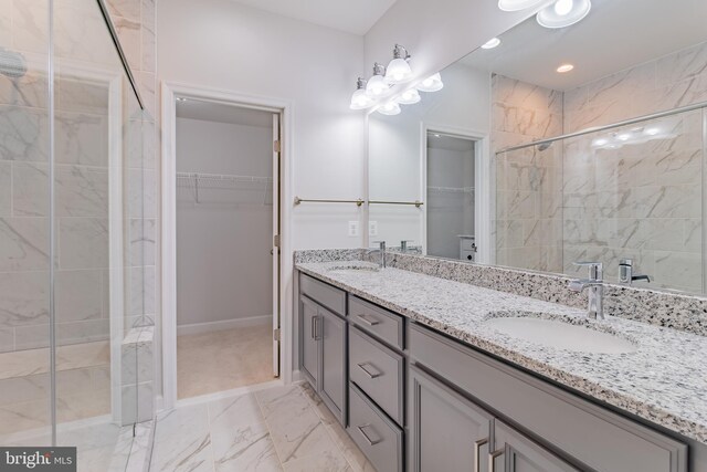 627 Halsey Way, Oxon Hill, MD 20745 - full bath featuring a walk in closet, double vanity, a shower stall, and marble look tiles