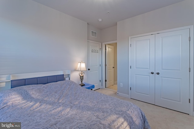 bedroom featuring a closet and light colored carpet