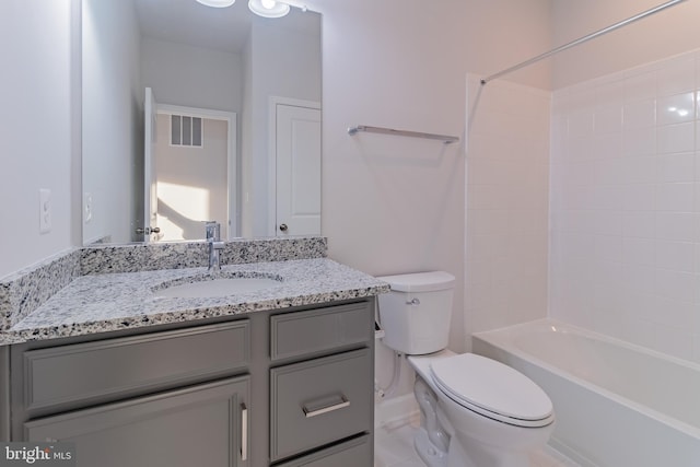 full bathroom featuring washtub / shower combination, vanity, and toilet