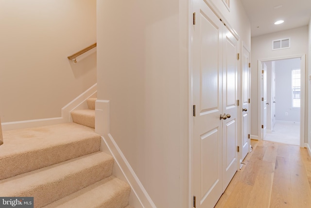 stairs with wood-type flooring