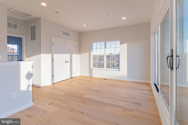 empty room with light hardwood / wood-style flooring