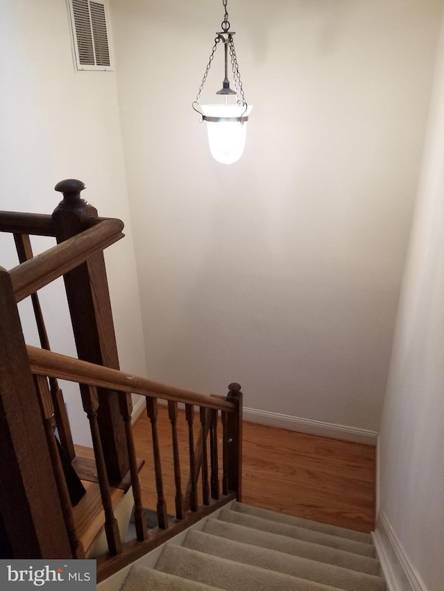 stairs with hardwood / wood-style flooring