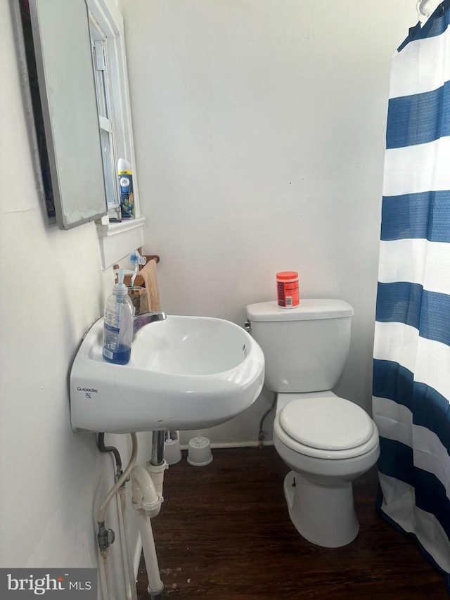 bathroom with sink, toilet, a shower with shower curtain, and hardwood / wood-style flooring