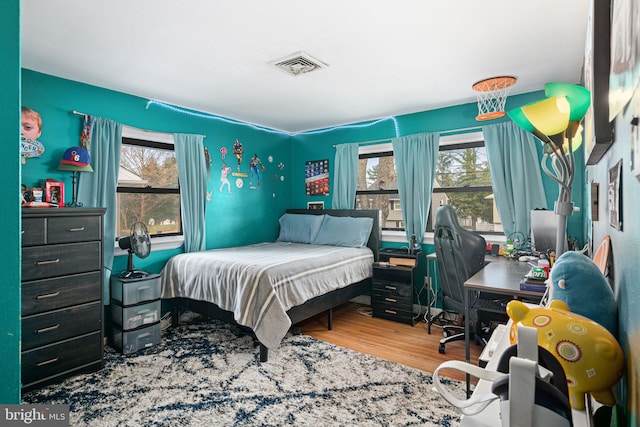 bedroom with hardwood / wood-style floors