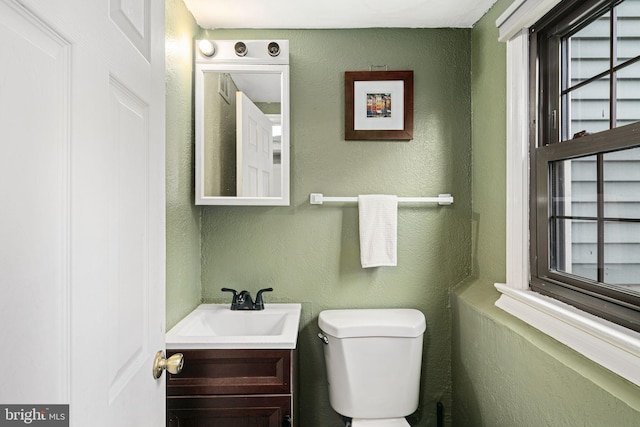 bathroom featuring toilet and vanity