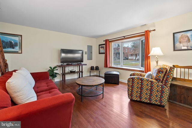 living room with electric panel and hardwood / wood-style flooring