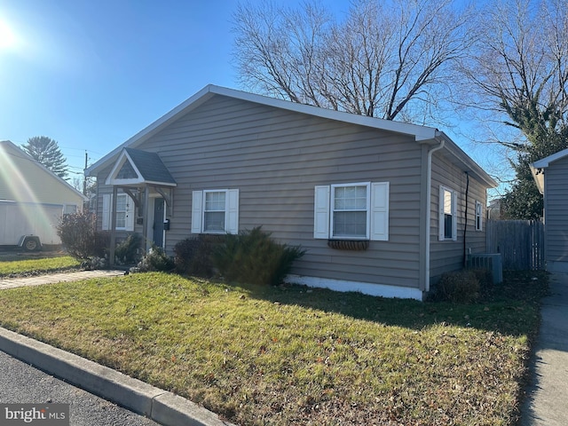 view of front of home with a front lawn and central air condition unit