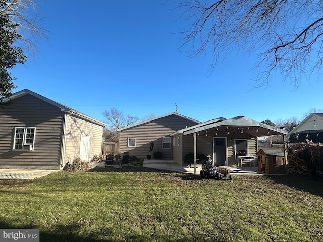 back of property featuring a patio area and a yard