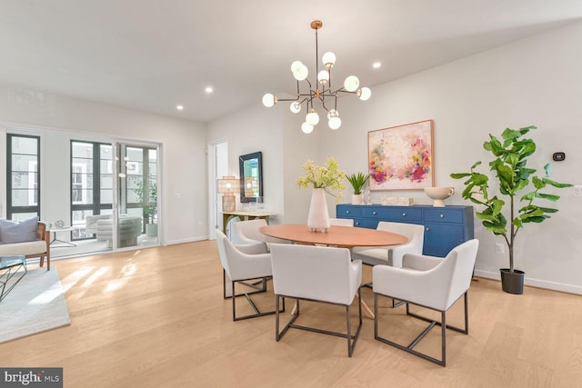 dining room featuring light hardwood / wood-style flooring and an inviting chandelier