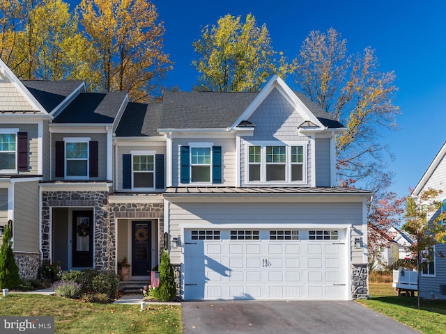 view of front of property featuring a front yard and a garage