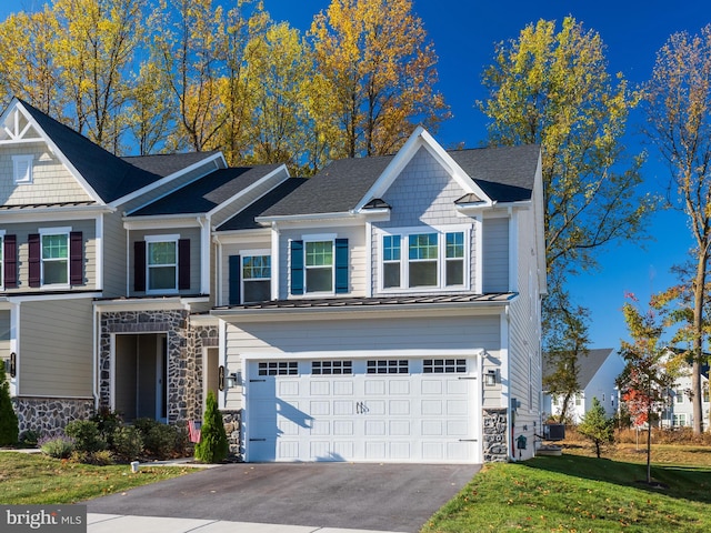 view of front of house with a garage and a front lawn