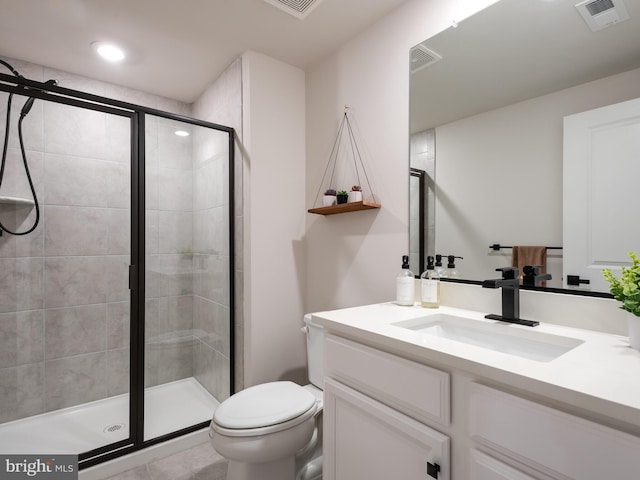 bathroom featuring tile patterned floors, vanity, toilet, and an enclosed shower