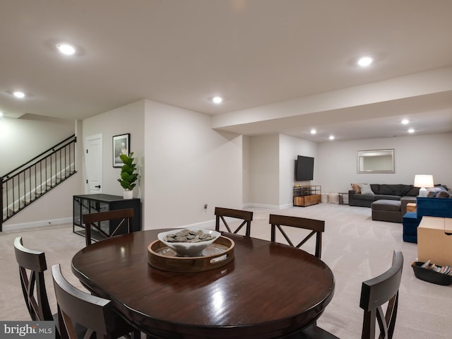 dining area with light colored carpet