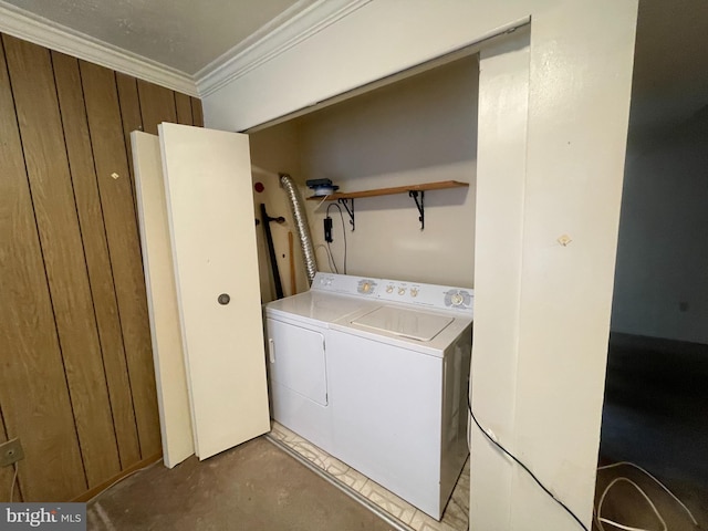 laundry area featuring washer and dryer and ornamental molding