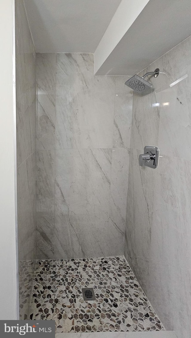 bathroom with a tile shower