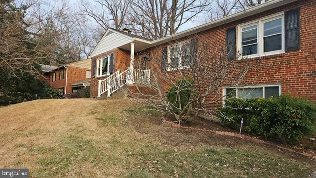 view of side of home with a yard