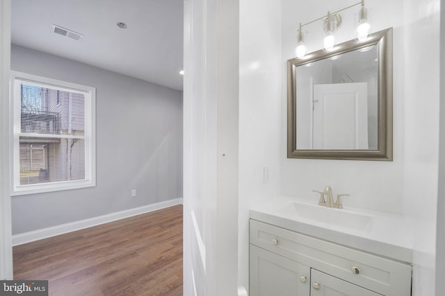 bathroom featuring plenty of natural light, vanity, and hardwood / wood-style flooring