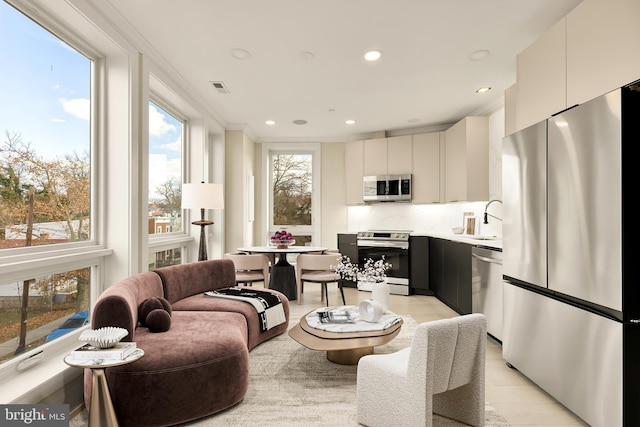 living room with sink and light hardwood / wood-style flooring