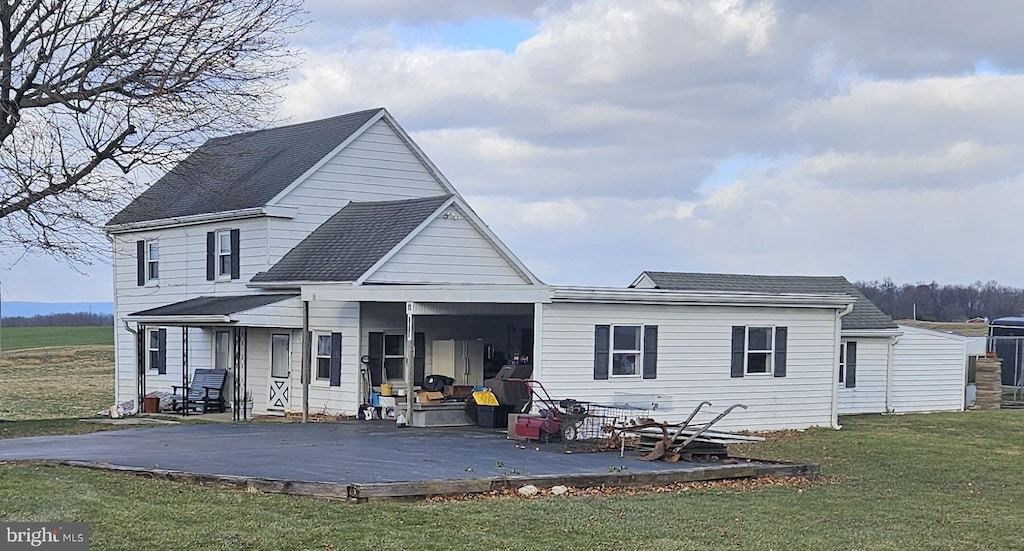 rear view of house with a yard and a deck