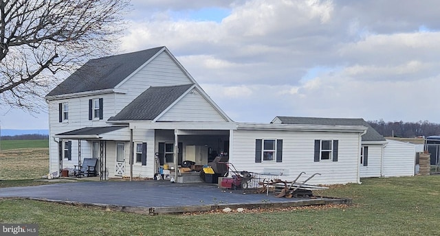 rear view of house with a yard and a deck