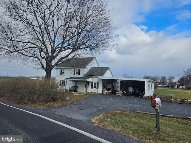 view of front of home with a front yard and a carport