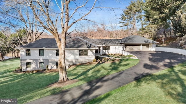 view of front of house featuring a garage and a front lawn