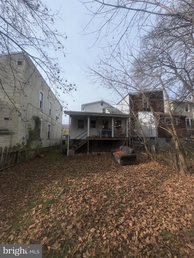 rear view of property with a porch