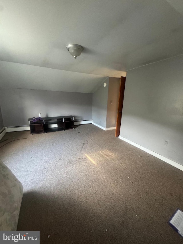 bonus room with vaulted ceiling and a baseboard heating unit