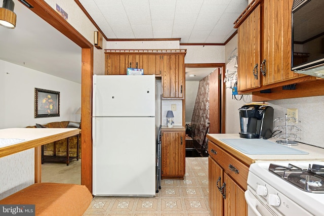 kitchen with white appliances and ornamental molding