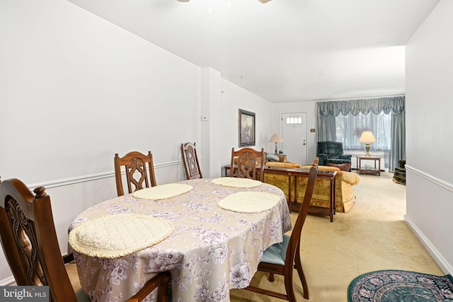 dining area featuring light colored carpet