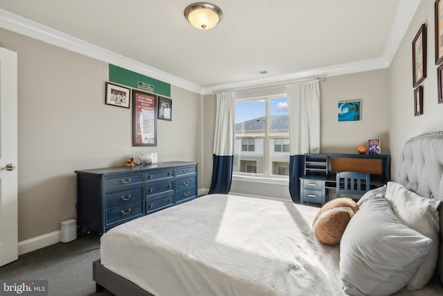 bedroom with crown molding and carpet floors