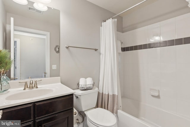 full bathroom with shower / bath combination with curtain, toilet, and vanity