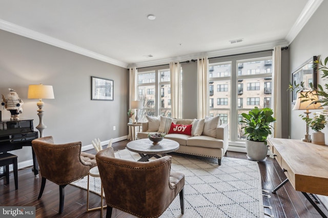 living room with hardwood / wood-style flooring and crown molding