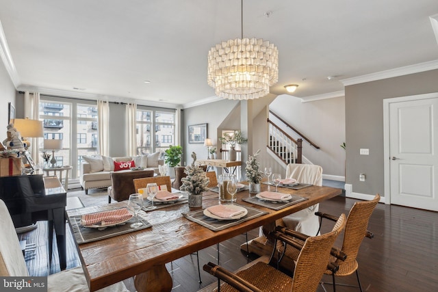 dining room with dark hardwood / wood-style floors, crown molding, and a notable chandelier