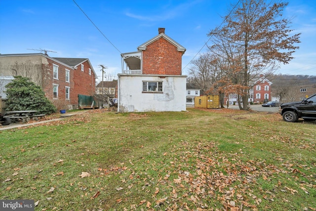 rear view of property with a yard