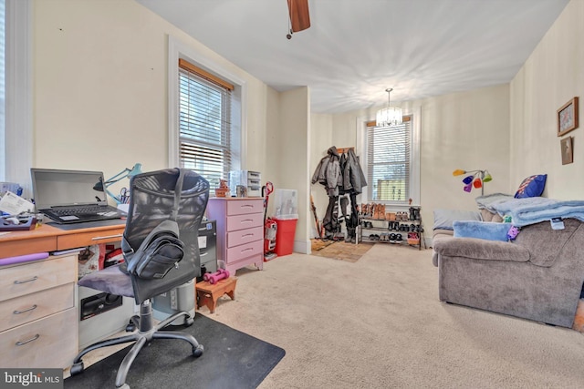 office space with carpet and an inviting chandelier