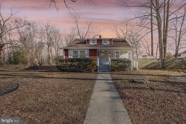 bungalow featuring a yard and a porch