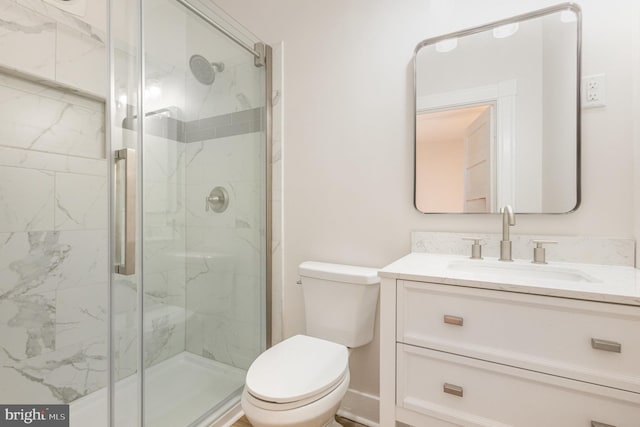 bathroom featuring vanity, toilet, and a shower with shower door