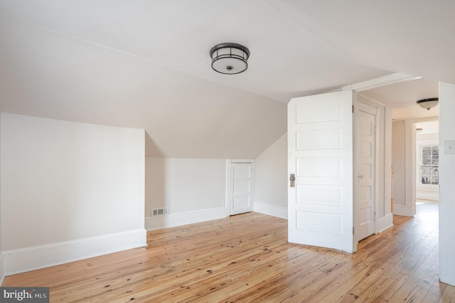 additional living space with light hardwood / wood-style floors