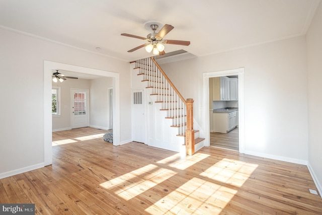 empty room featuring ceiling fan, light hardwood / wood-style floors, and ornamental molding