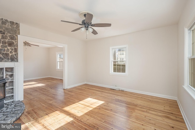 unfurnished living room with light hardwood / wood-style floors, plenty of natural light, and ceiling fan