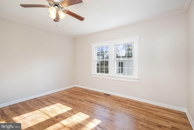 empty room with light hardwood / wood-style flooring, ceiling fan, and ornamental molding